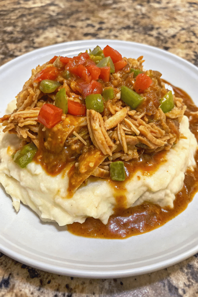 Skillet of Spicy Southern Chicken and Gravy with tender chicken in buttery pepper gravy