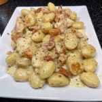 Creamy Chicken and Gnocchi in a skillet with tender chicken, soft gnocchi, Parmesan cream sauce, and sun-dried tomatoes