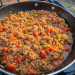 Unstuffed Pepper Skillet Recipe with ground beef, rice, bell peppers, and tomato sauce in a large skillet