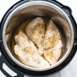 Tender and juicy CrockPot Frozen Chicken Breasts cooked in a flavorful broth, ready to serve.
