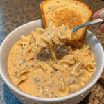 Creamy Chicken Alfredo pasta with sliced chicken, rich Alfredo sauce, and fresh parsley garnish