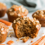 Freshly baked Healthy Carrot Cake Muffins made with grated carrots, banana, maple syrup, and walnuts, served on a cooling rack.