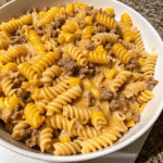 Loaded Cheddar Ranch Beef pasta bake with creamy cheddar sauce, seasoned ground beef, and corn, topped with melted cheese and parsley