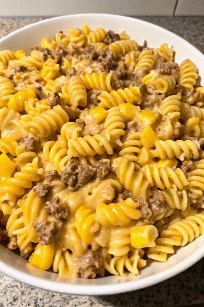 Creamy Loaded Cheddar Ranch Beef casserole with rotini, melted cheese, and golden baked topping