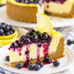 Lemon Blueberry Cheesecake with whipped cream and fresh blueberries on a serving plate