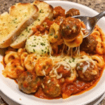 Slow Cooker Tortellini Meatball Casserole with melted mozzarella, tender meatballs, and tortellini in rich marinara sauce, ready to serve.