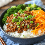 Korean Ground Beef Bowl with savory ground beef, jasmine rice, broccoli, and shredded carrots topped with green onions and sesame seeds.
