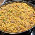 A bowl of homestyle cheesy Rotel spaghetti with ground beef, melted cheese, and diced tomatoes with green chilies