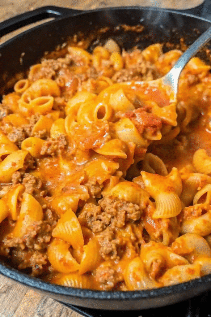 Close-up of Beefy Shells And Cheese topped with savory ground beef and smooth cheesy sauce.