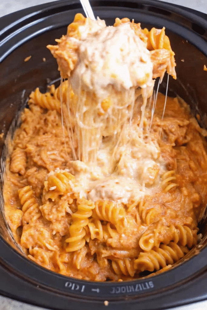 Close-up of Crockpot Chicken Pasta featuring cheesy rotini, slow-cooked chicken, Parmesan, and rich creamy sauce.