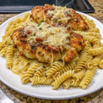 Homemade Marry Me Chicken in a skillet with creamy Parmesan sauce and sun-dried tomatoes