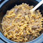 Slow Cooker Beef And Noodles served in a bowl with tender shredded beef, egg noodles, and rich brown gravy