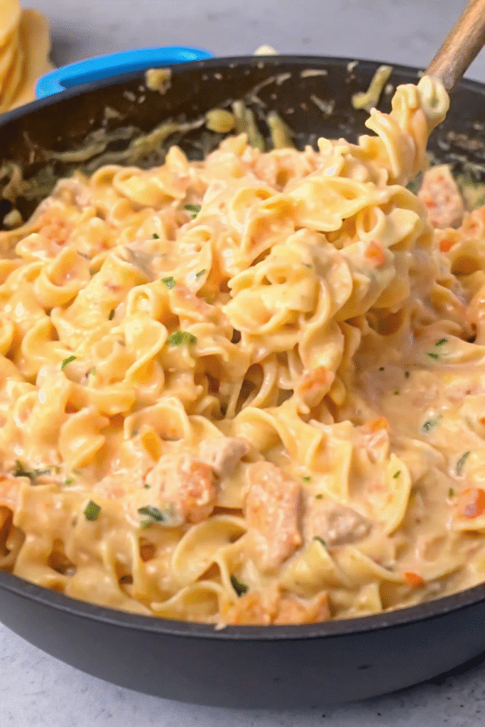Homemade Creamy Chicken with Egg Noodles topped with parsley, featuring tender chicken pieces in a velvety sauce.