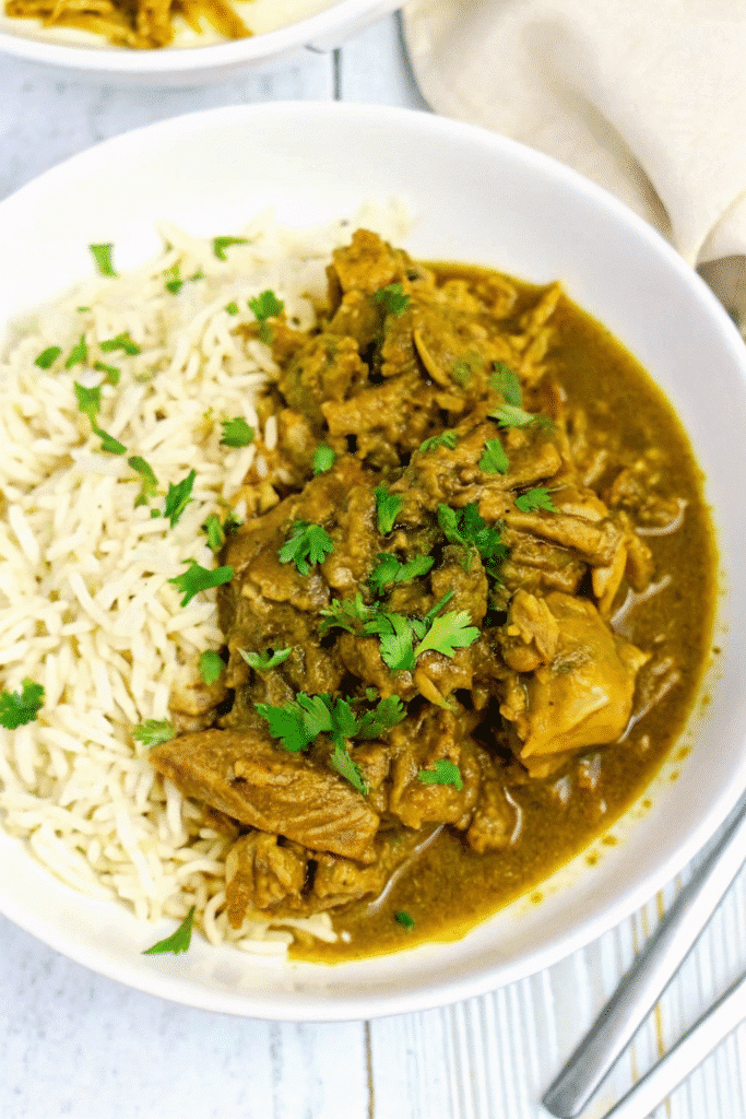 Slow cooker Crock Pot Chicken Curry with soft chicken thighs simmered in a rich, spiced coconut and mango chutney sauce.