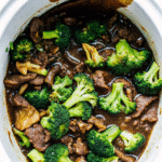 Slow cooker Crock Pot Beef and Broccoli with tender beef strips and broccoli coated in a rich soy garlic sauce served over rice.