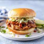 Crockpot Pulled Pork Bbq served with tender shredded pork in barbecue sauce, shown in a slow cooker with rich, juicy texture.
