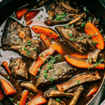 Slow cooked Crock Pot Barbecue Ribs made with beef short ribs, onions, carrots, and herbs in a rich savory sauce, served tender and fall-apart style.