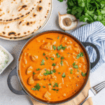 Golden baked Famous Butter Chicken coated in buttery cracker crumbs, served in a baking dish with crispy edges and juicy chicken inside.