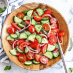 Fresh Cucumber Tomato Salad made with sliced cucumbers, ripe tomatoes, red onion, and herbs in a light olive oil dressing.