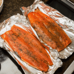 Smoked salmon fillet with a brown sugar and dill crust, freshly sliced and served with a smoky glaze.