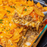 Cheesy Hashbrown Dorito Casserole baked with ground beef, melted Colby Jack cheese, crispy Doritos, and creamy hashbrowns.