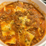 Cheesy Slow Cooker Lasagna served in a bowl with ground beef, sausage, melted mozzarella, ricotta, and tender pasta in rich marinara sauce