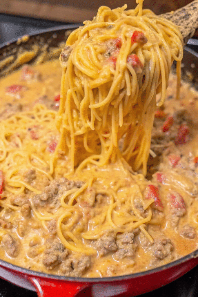 Close-up of Cheesy Taco Spaghetti with spaghetti noodles coated in creamy taco cheese sauce and savory ground beef.