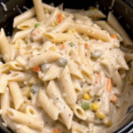 Crockpot Chicken Pot Pie Pasta with tender chicken, creamy sauce, mixed vegetables, and rotini pasta in a slow cooker