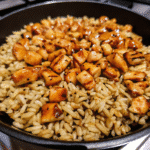 One Pan Bold Honey BBQ Chicken Rice with glazed chicken, fluffy rice, and mixed vegetables in a skillet