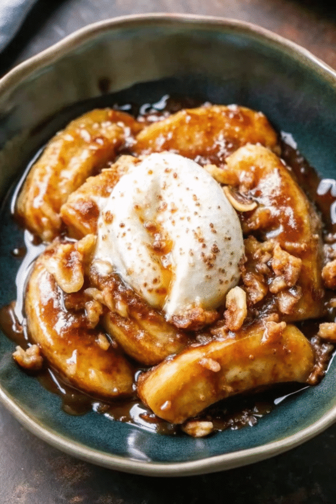 Close-up of Bananas Foster with caramelized bananas in a rum-brown sugar sauce over ice cream.