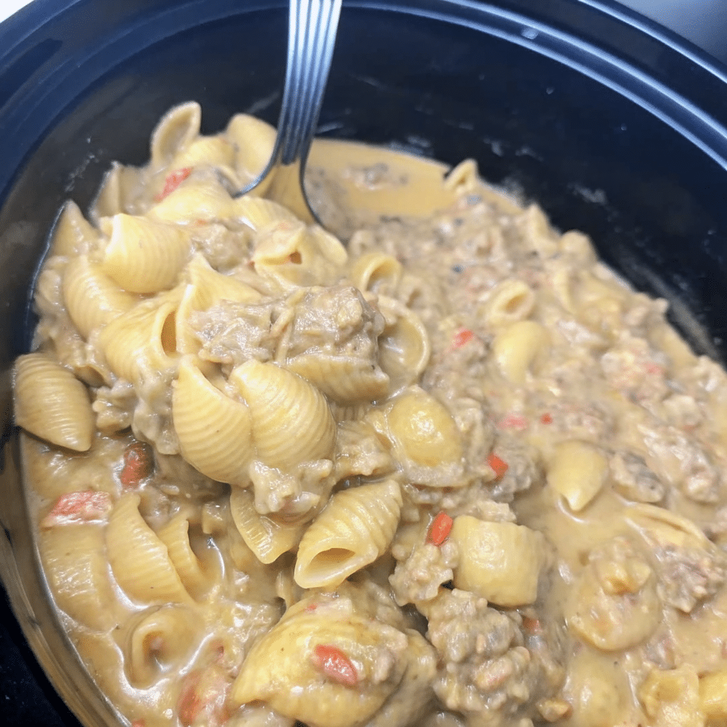Creamy Nacho Beef And Shell Pasta made with ground beef, pasta shells, Rotel tomatoes, and melted cheddar cheese in a rich sauce.