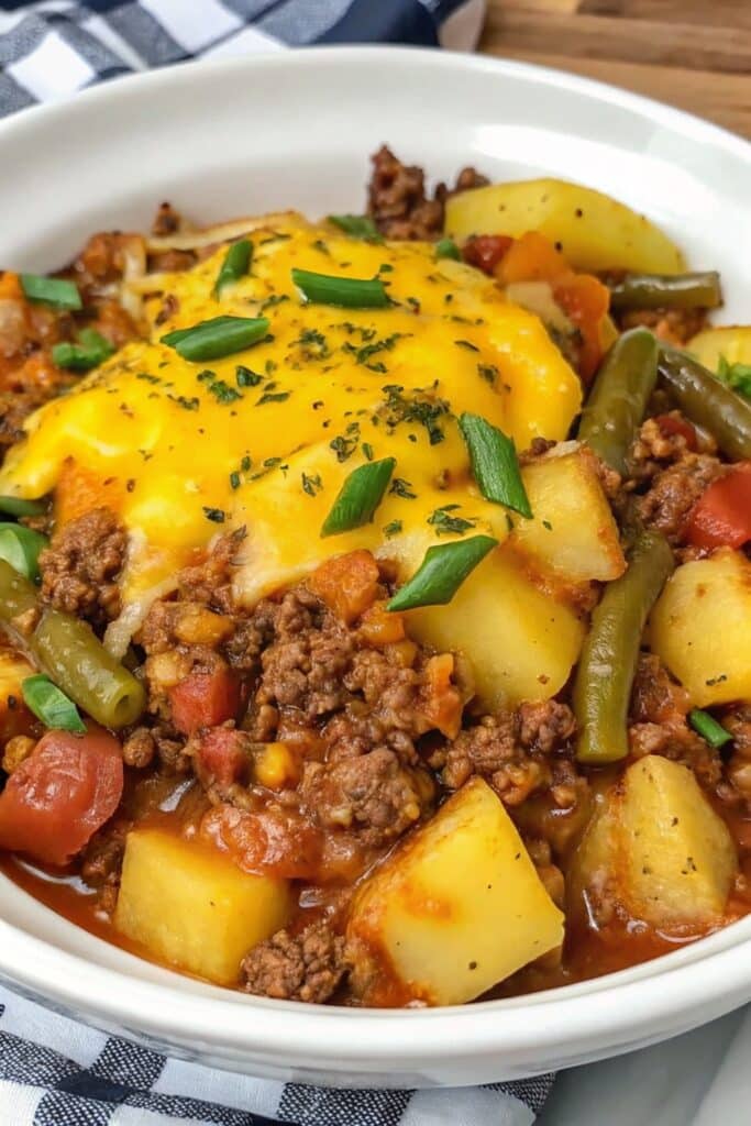 Hobo Casserole with Ground Beef 4 Freshly baked Hobo Casserole with Ground Beef served warm, loaded with seasoned beef, potatoes, green beans, and tomatoes.