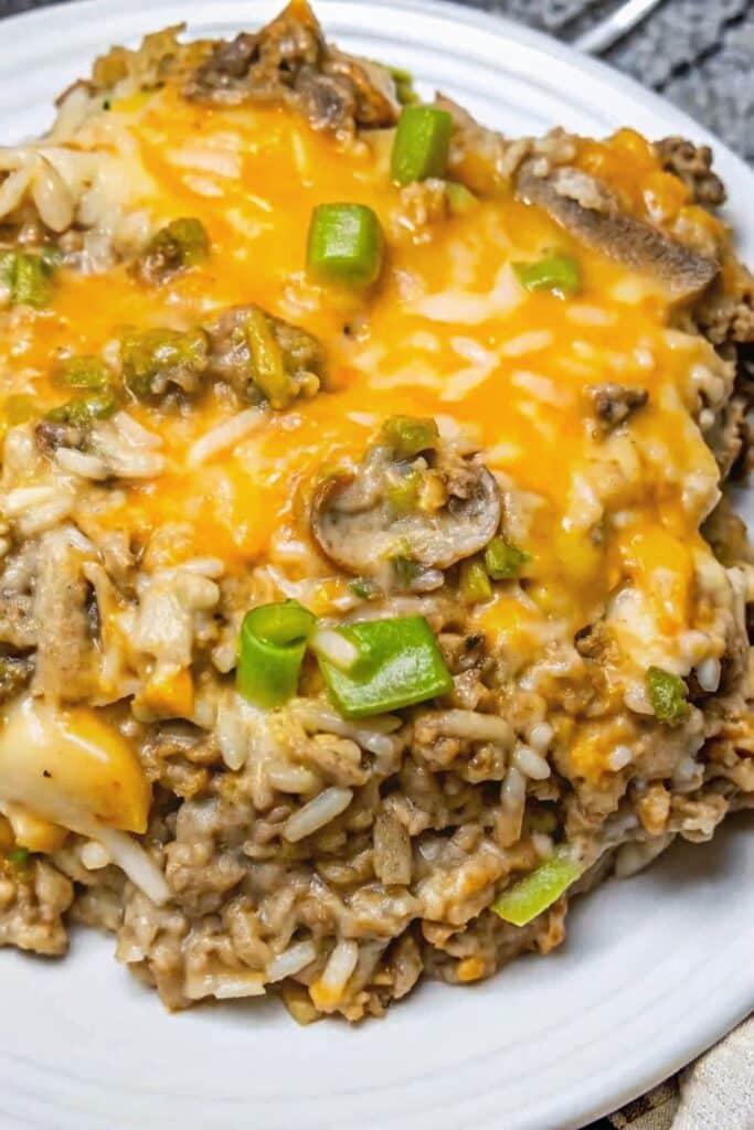 Creamy Philly Cheesesteak Ground Beef served hot with ground beef, instant rice, bell peppers, mushrooms, and a cheesy topping.