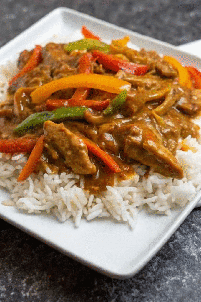 Pepper Chicken with Rice served with tender chicken, colorful bell peppers, savory gravy, and fluffy white rice.
